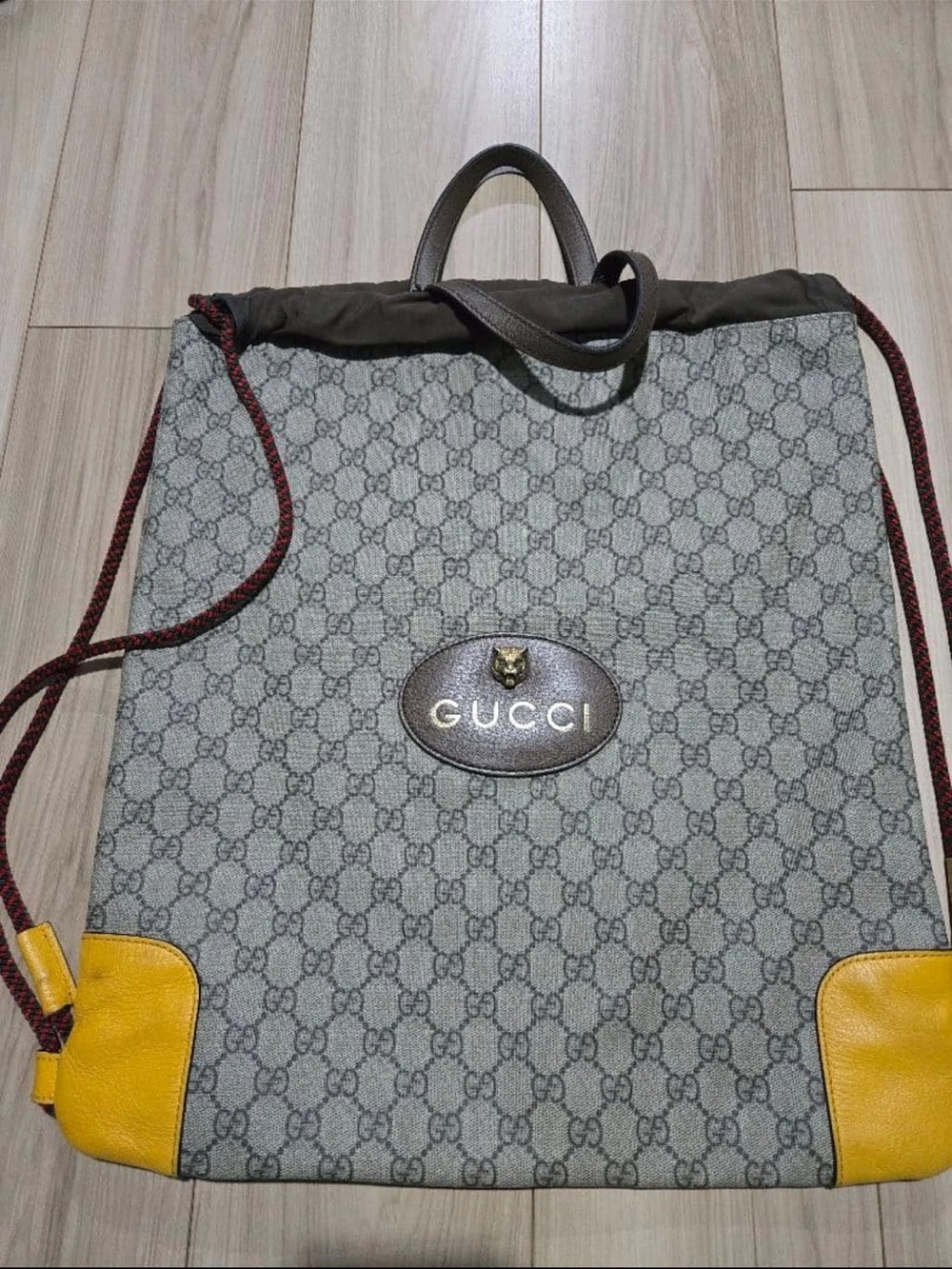 Gucci Grey GG Supreme Drawstring Backpack with Yellow Corner Accents